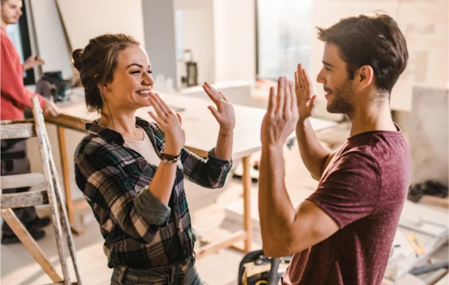 A man and woman playing patty cake.