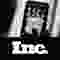 A smartphone held up by one hand, above a black bar with the logotype "Inc."